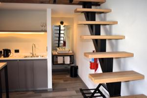 a kitchen with wooden shelves on the wall at Merinos Lodge 1 in El Calafate