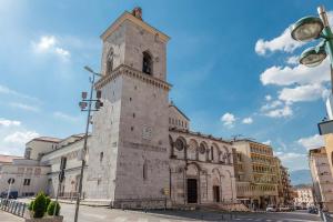 an old stone building with a clock tower on a street at B&B 31 mt dal Duomo in Benevento