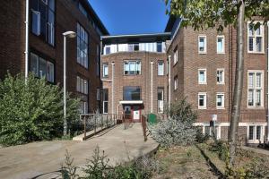 a brick building with a walkway in front of it at For Students Only - Library Lofts in Exeter in Exeter