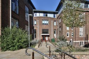 a brick building with a staircase in front of it at For Students Only - Library Lofts in Exeter in Exeter