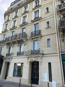 a large building with windows and a door at Eiffel Yard Hotel in Paris
