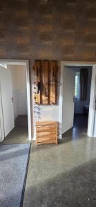 a room with two doors and a shelf with wine bottles at Ferienhaus LODA - Garten, Netflix & Spreewald Flair in Heinersbrück