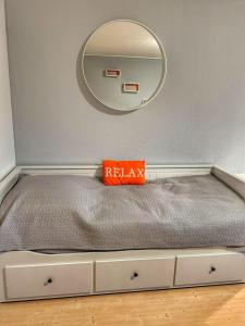 a bed in a room with a mirror at 1 Zimmer Apartment in Wuppertal +5 photos