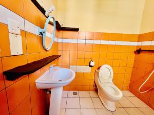 a bathroom with a toilet and a sink at Cozy Beachside Retreat in Diani Kwale County in Galu +13 photos
