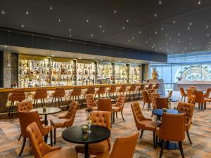 a restaurant with tables and chairs and a bar at Minaro Hotel Tokaj - MGallery Collection in Tokaj