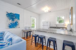 a kitchen with a counter and stools in a room at Shirley Road Cottage by Tybee Cottages in Tybee Island