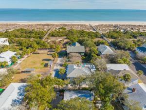 an aerial view of a house with the ocean in the background at Shirley Road Cottage by Tybee Cottages in Tybee Island