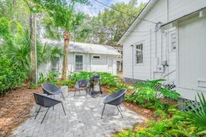 a patio with chairs and a grill in front of a house at Shirley Road Cottage by Tybee Cottages in Tybee Island +18 photos