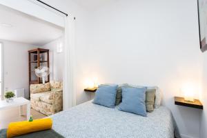 Un dormitorio con una cama con almohadas azules. en Apartamento Retama Laguna Centro, en La Laguna