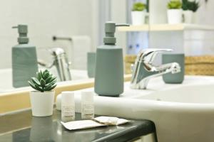 a bathroom with two bottles of soap and a sink at Bilocale Nova Milanese vicino Milano Monza - Parcheggio, terrazzo, Wifi, AC, Netfilx - in Nova Milanese +25 photos