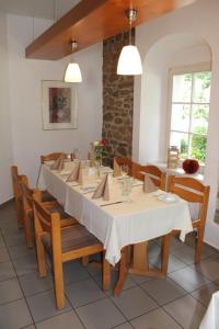 a dining room with a long table and chairs at Hotel Hohe Reuth in Bocka