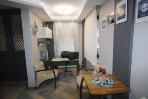 an office with a desk and chairs and a table at Hotel Taksim Home in Istanbul