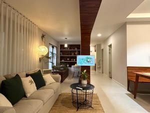 a living room with a couch and a tv at Dal Dam, a pet-friendly accommodation in the west of Jeju, a private underground bunker event room for family groups in Ŭmbu-dong