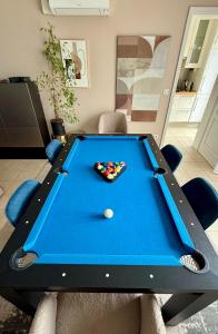 a pool table in a living room with at Appartement climatisé 3 étoiles T3 chic à Strasbourg avec billard et terrasse in Strasbourg