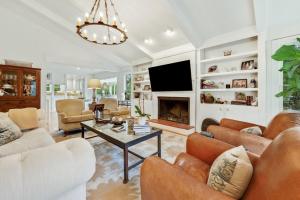 a living room with a couch and a fireplace at Sunny Pointe home in DeBordieu