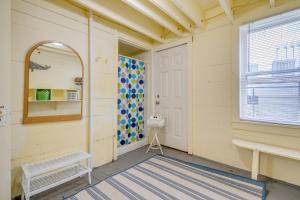 a room with a door and a bench and a window at Paradise Palms by Tybee Cottages in Tybee Island +38 photos