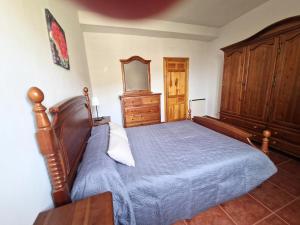 a bedroom with a bed and a wooden dresser at The Retreat, Alcazar in Órgiva +30 photos