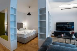 ein Schlafzimmer mit Bett und ein Wohnzimmer in der Unterkunft Cuza 16 - Central Premium Apartments in Braşov