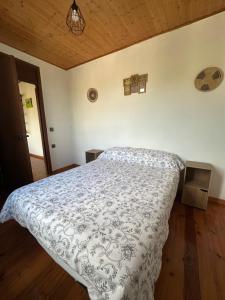 a bedroom with a bed with a white comforter at Casa Rural Melon in Melón