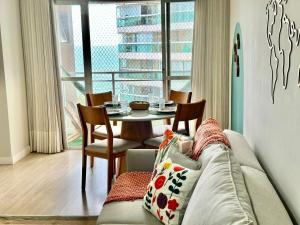 a living room with a couch and a table at M901 Vista Mar Ar Cond Garagem in Vila Velha +13 photos