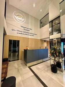 a lobby with a reception desk in a building at Promoção em Bombinhas até 4 pessoas c Piscina Aquecida in Bombinhas +41 photos