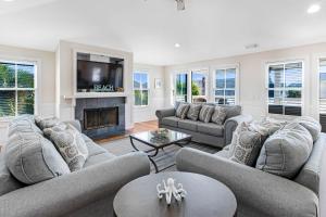 a living room with couches and a fireplace at SeaStarr by Tybee Cottages in Tybee Island