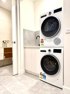 two washing machines are in a laundry room at Williamstown Village in Williamstown