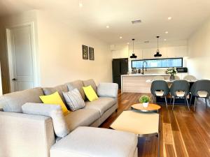 a living room with a couch and a kitchen at Williamstown Village in Williamstown