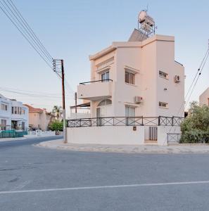 a building on the side of a street at TelMar Sunset View 3 bed Apt - Duplex in Livadhia