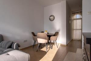 a dining room with a table and chairs at 3BR Sunset View Retreat Steps from the Beach by Cyprus Horizons in Oroklini