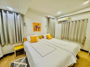 Ένα ή περισσότερα κρεβάτια σε δωμάτιο στο BaanSpired CHIANG MAI