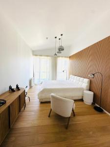 a bedroom with a bed and a desk and a chair at White & Wood Suite C302, at Euphoria SPA Borovets in Borovets +47 photos