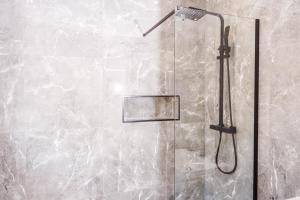 a shower with a shower head in a bathroom at The Langdale House in Broadheath +53 photos