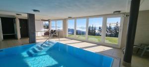 a large swimming pool with a view of the mountains at Erholungskanzel in Treffen