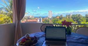 a laptop computer sitting on a table with a plate of fruit at OASIS VILLA Karon Beach in Karon Beach +64 photos