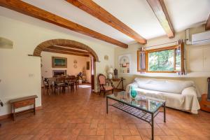 a living room with a couch and a table at La casa di Oliveto Private villa with pool in Oliveto +31 photos
