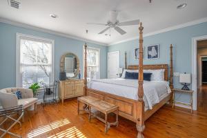 a bedroom with a bed and a ceiling fan at Gone Coastal by Tybee Cottages in Tybee Island