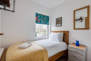 a bedroom with a bed with a mirror and a window at Family Home W Patio & Serene Backyard in Oxford