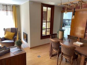 a living room with a wooden table and chairs at Porto Nest in Senhora da Hora +18 photos