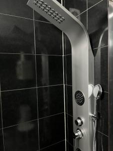 a shower with a glass door in a bathroom at Porto Nest in Senhora da Hora
