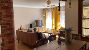 a living room with a table and a television at Porto Nest in Senhora da Hora