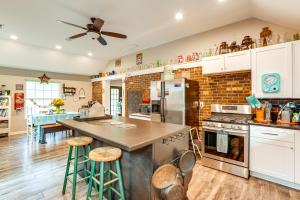 a kitchen with white cabinets and a brick wall at Otter Creek Rec Area On-Site! Serene Family Home in Muldraugh