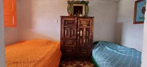 a bedroom with a bed and a dresser with a mirror at La jinquita in La Unión