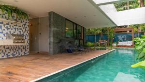 a house with a swimming pool and a patio at Casa Forte Prince - Flat a 500m do Shopping Plaza by Yolo in Recife
