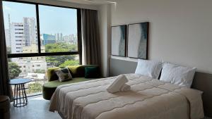 a bedroom with a large bed and a large window at Casa Forte Prince - Flat a 500m do Shopping Plaza by Yolo in Recife +34 photos