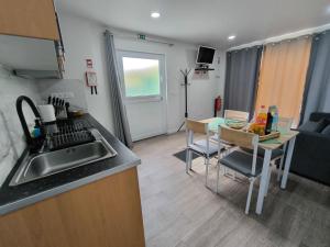 a kitchen and living room with a sink and a table at Flor da Natureza - Flor in Pilar
