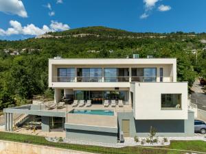 an aerial view of a house with a swimming pool at Villa Ladeti Sereno in Poljane