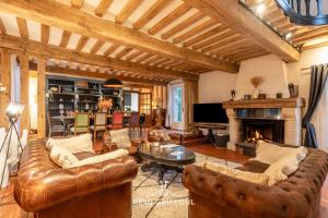 a living room with a couch and a fireplace at La Maison de la Corniche Enjoy an Authentic Stay in Normandy - 8 Pax in Barneville-la-Bertran