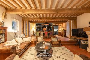 a living room with a couch and a table at La Maison de la Corniche Enjoy an Authentic Stay in Normandy - 8 Pax in Barneville-la-Bertran +24 photos