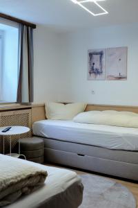 two beds sitting next to each other in a room at Haus Sepp Gruber in Sankt Anton am Arlberg